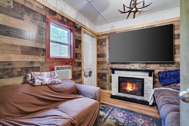 235 Scenic Dr, East Stroudsburg, PA 18302 - living area with wooden walls, wood finished floors, a chandelier, and a fireplace