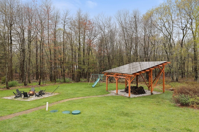 5175 White Birch Dr, Long Pond, PA 18334 - view of green lawn featuring a fire pit, a playground, and a wooded view