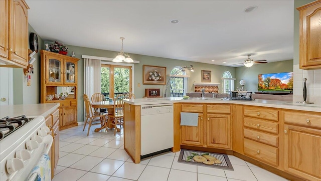 kitchen featuring white appliances, plenty of natural light, and light countertops