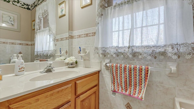 bathroom with tile walls and vanity