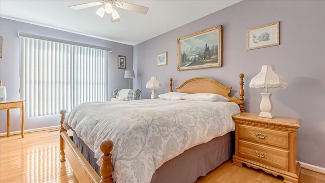 bedroom with light wood-style flooring, baseboards, and ceiling fan