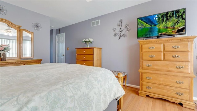 bedroom with baseboards, visible vents, and light wood-type flooring