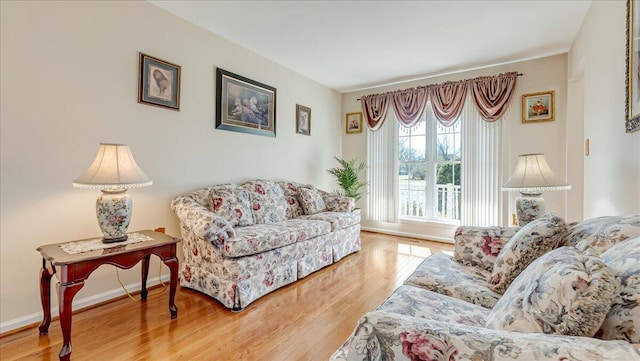 living area with wood finished floors and baseboards