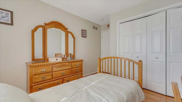 bedroom featuring visible vents, a closet, and light wood-type flooring