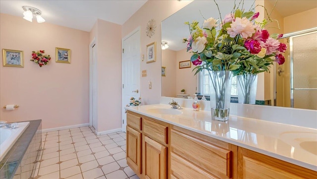 full bathroom with a sink, a relaxing tiled tub, a shower with door, and double vanity