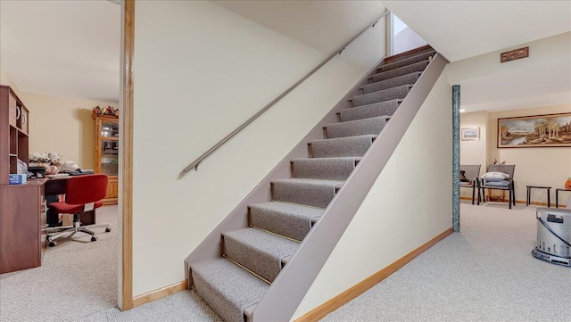 stairs featuring carpet flooring and baseboards