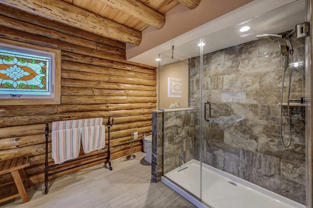 bathroom featuring beamed ceiling, a shower stall, toilet, rustic walls, and wooden ceiling