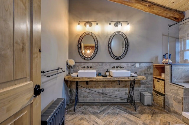 full bathroom featuring a sink, radiator, and beam ceiling