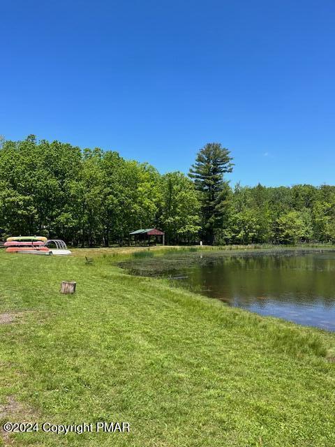 exterior space featuring a water view and a view of trees