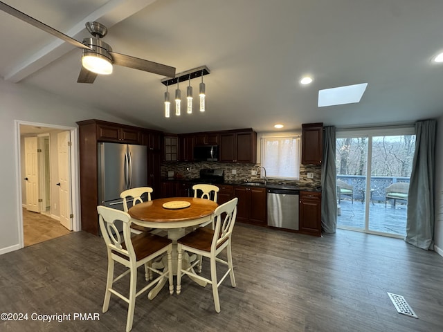 dining area featuring recessed lighting, wood finished floors, visible vents, a ceiling fan, and lofted ceiling with skylight