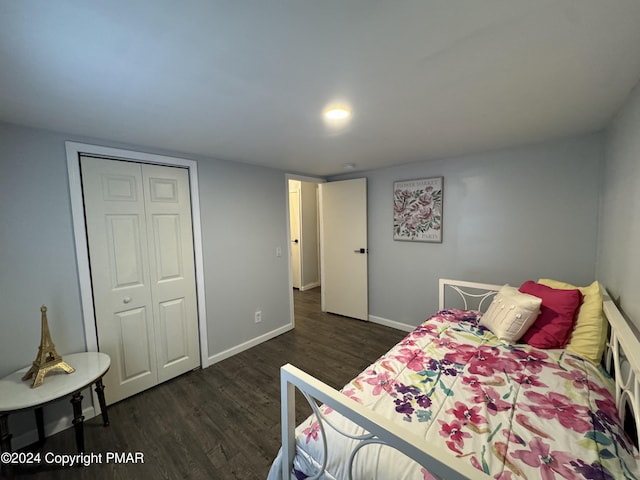 bedroom featuring a closet, baseboards, and wood finished floors