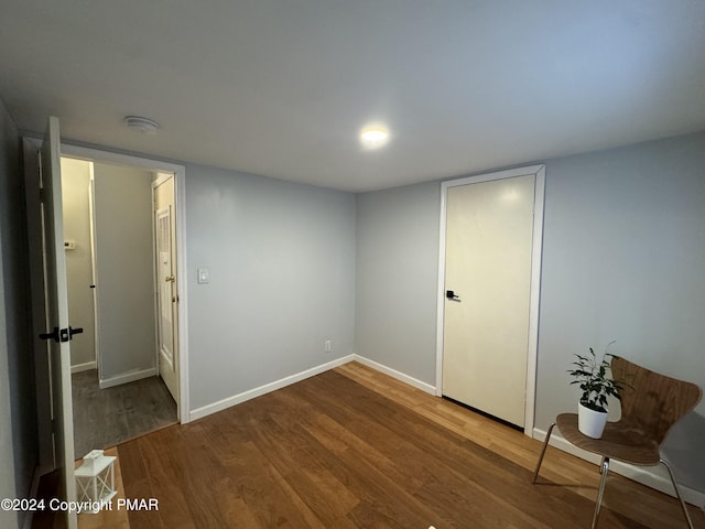 interior space with wood finished floors and baseboards