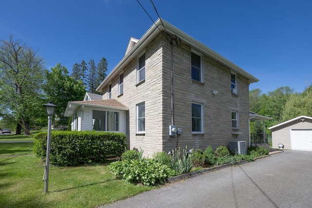 244 Learn Rd, Tannersville, PA 18372 - view of side of home with an outbuilding, a yard, a detached garage, asphalt driveway, and cooling unit