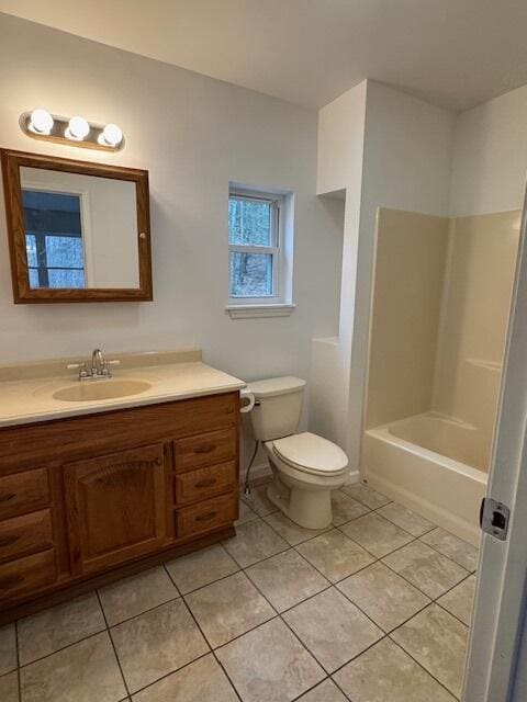 bathroom with tile patterned flooring, toilet, vanity, and a bathtub