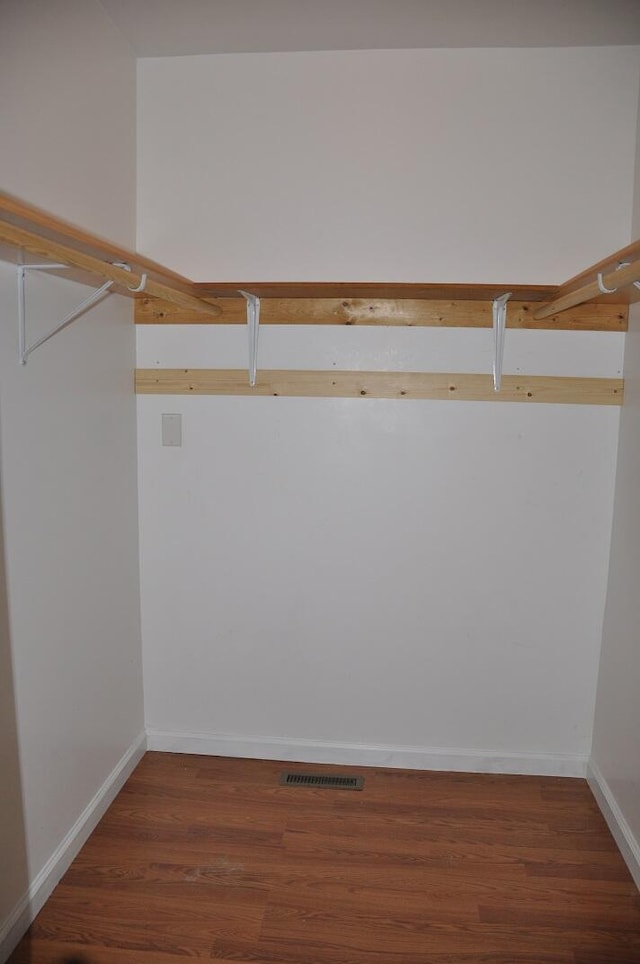 spacious closet featuring visible vents and wood finished floors