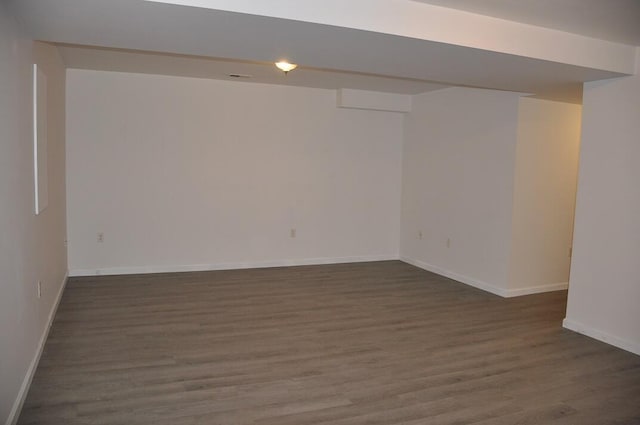 empty room with baseboards and wood finished floors