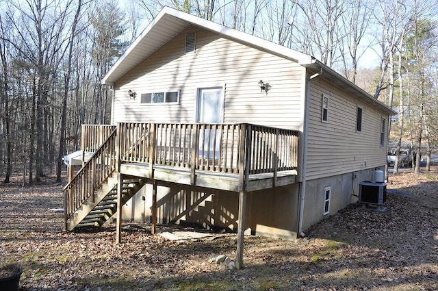 back of property featuring stairs, a deck, and central AC unit