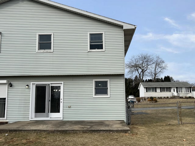 rear view of house featuring a patio area and fence