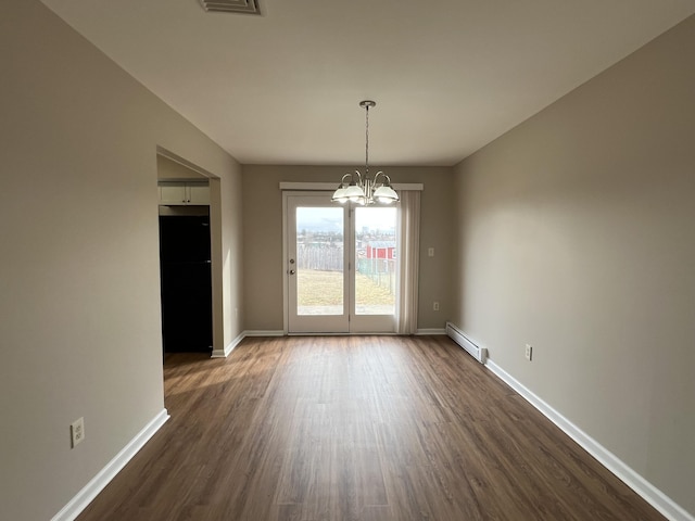 unfurnished dining area featuring visible vents, a baseboard heating unit, dark wood-style floors, an inviting chandelier, and baseboards