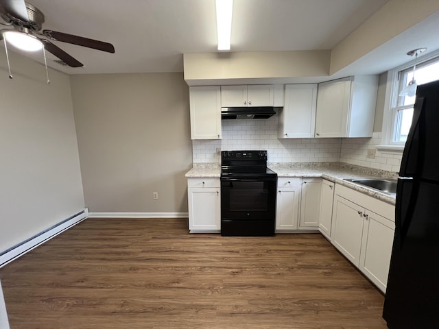 kitchen featuring under cabinet range hood, decorative backsplash, black appliances, a ceiling fan, and dark wood-style flooring