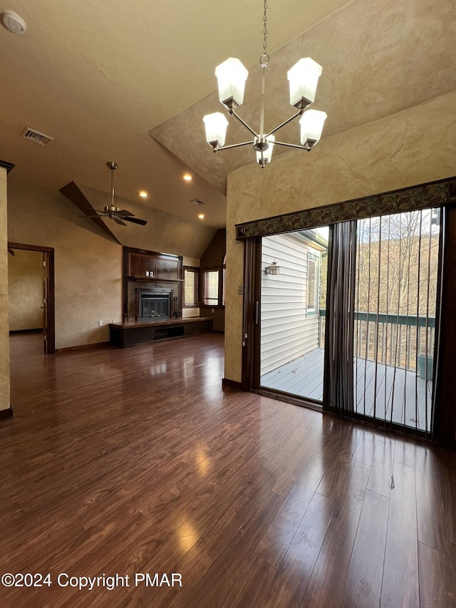 unfurnished living room featuring a glass covered fireplace, wood finished floors, visible vents, and a healthy amount of sunlight