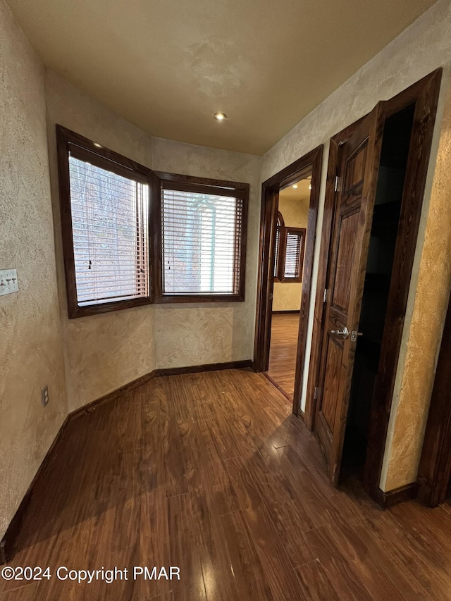 unfurnished room featuring dark wood-style floors