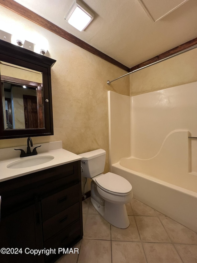 bathroom with a textured wall, toilet, washtub / shower combination, vanity, and tile patterned flooring