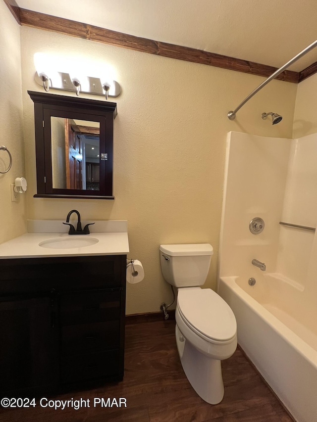 bathroom featuring vanity, shower / bath combination, wood finished floors, and toilet