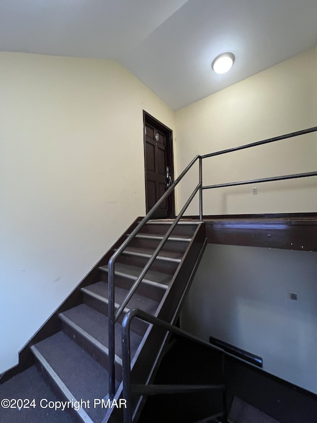 stairway with lofted ceiling