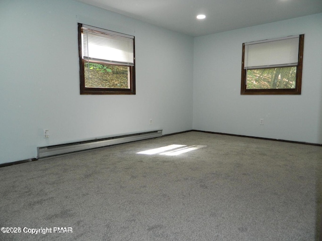 empty room featuring recessed lighting, a baseboard radiator, carpet flooring, and baseboards