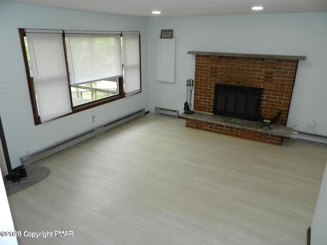 unfurnished living room with recessed lighting, a fireplace, baseboard heating, and wood finished floors