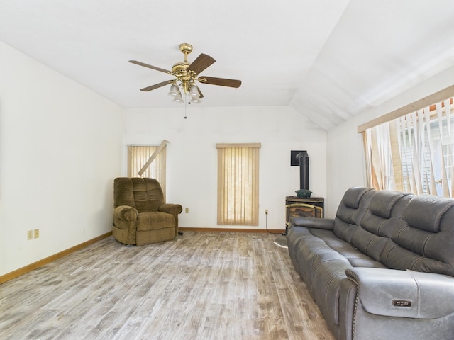 114 Oswayo Dr, Pocono Lake, PA 18347 - living room with a wood stove, wood finished floors, baseboards, ceiling fan, and vaulted ceiling