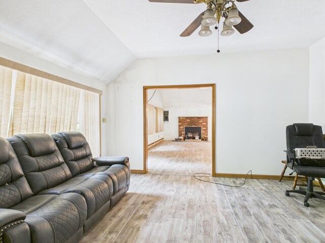 114 Oswayo Dr, Pocono Lake, PA 18347 - living room with wood finished floors, a ceiling fan, lofted ceiling, baseboards, and a brick fireplace