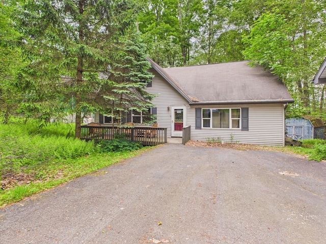 114 Oswayo Dr, Pocono Lake, PA 18347 - view of front facade featuring a wooden deck and asphalt driveway