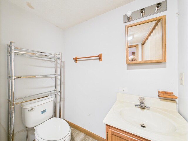 114 Oswayo Dr, Pocono Lake, PA 18347 - bathroom featuring toilet, vanity, baseboards, and wood finished floors