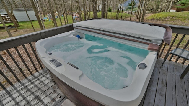 deck with a covered hot tub
