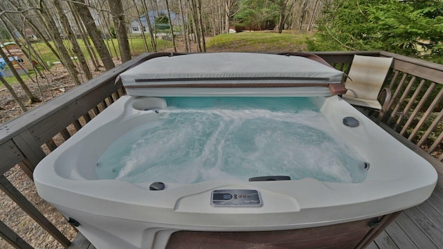 deck featuring a covered hot tub