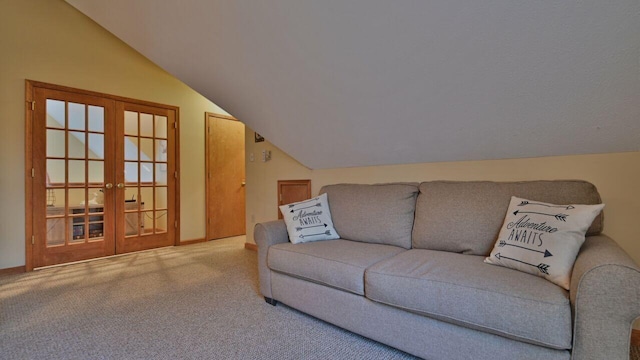living room featuring baseboards, french doors, carpet flooring, and lofted ceiling