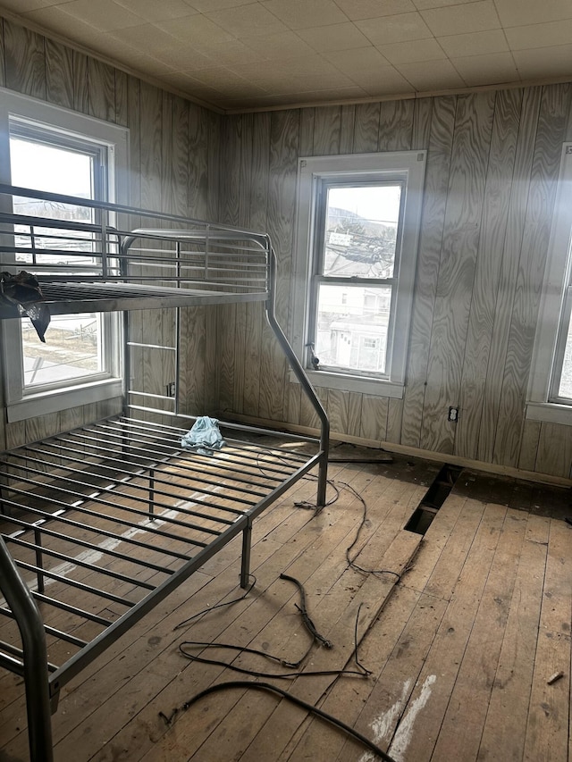 unfurnished bedroom featuring hardwood / wood-style flooring and multiple windows