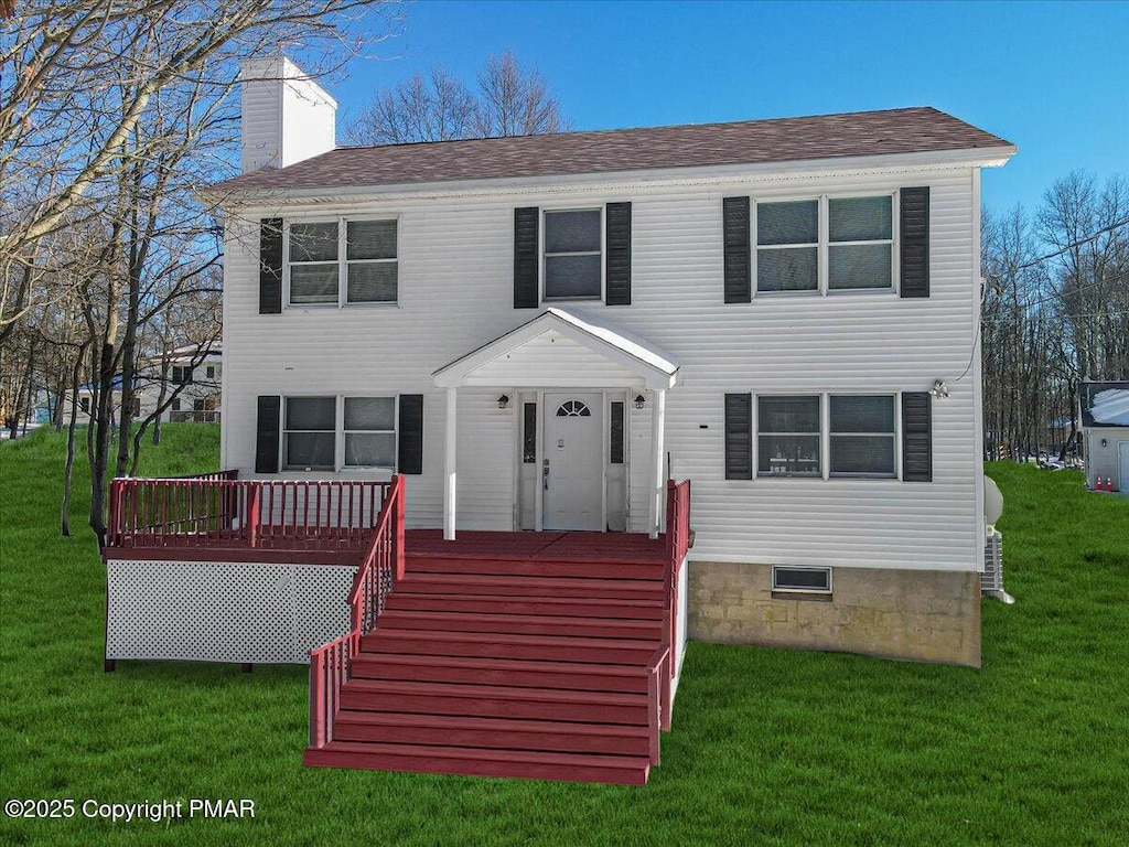 colonial home with a chimney and a front lawn