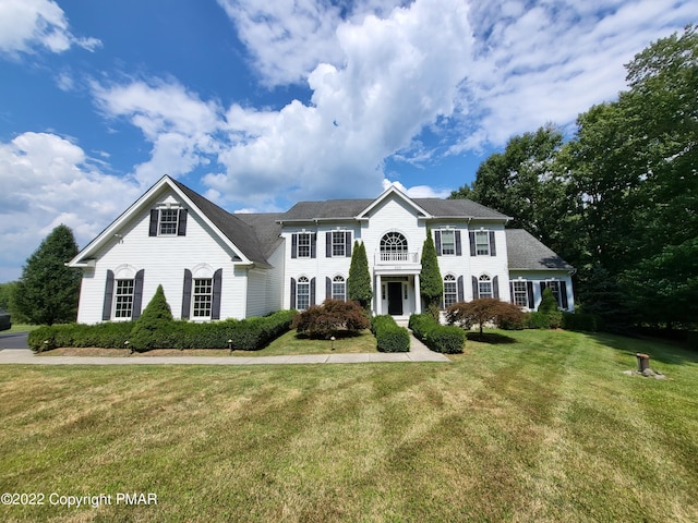 colonial home featuring a front yard