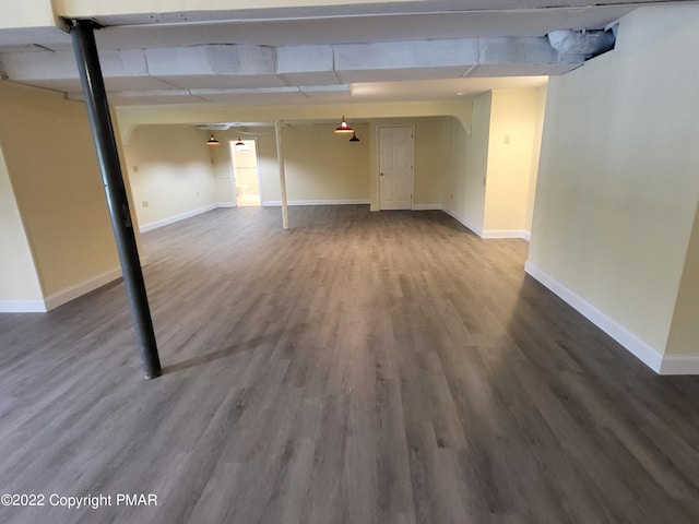 finished basement featuring baseboards and wood finished floors