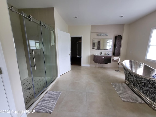 full bathroom featuring a stall shower, plenty of natural light, and a freestanding tub