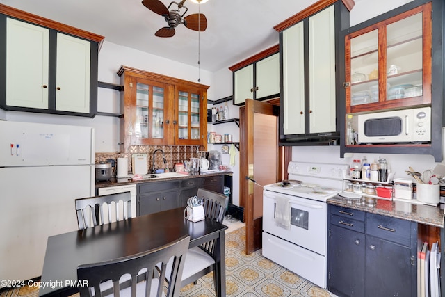 kitchen featuring white appliances, a ceiling fan, glass insert cabinets, a sink, and backsplash