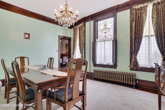 dining space with ornamental molding, carpet, radiator, and an inviting chandelier