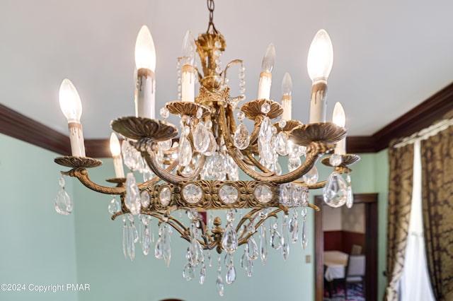 room details featuring crown molding and a notable chandelier