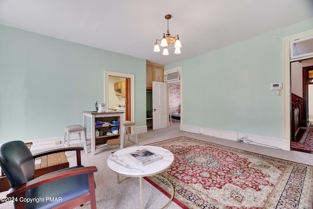 carpeted living area featuring baseboards and a chandelier