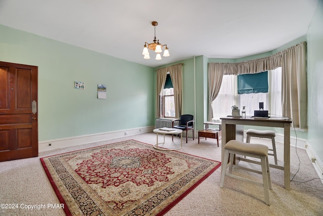 sitting room featuring carpet, a chandelier, and baseboards