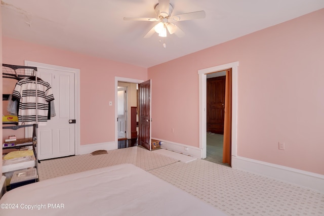 bedroom featuring carpet floors, baseboards, and a ceiling fan