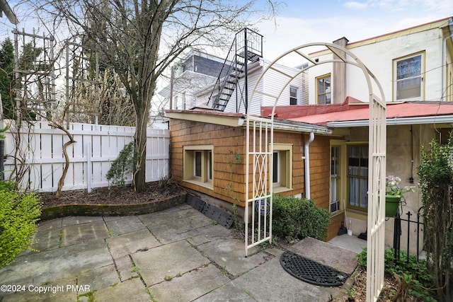 exterior space featuring a patio area and fence